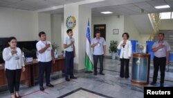 Участкалык шайлоо комиссиясынын мүчөлөрү добуш берүү ачылып жаткан кезде.