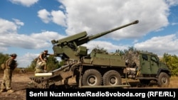 The Ukrainian military prepares to fire a self-propelled howitzer at Russian positions in eastern Ukraine.