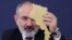 Armenia - Prime Minister Nikol Pashinian holds a cardboard cutout of Armenia at a news conference in Yerevan, March 12, 2024,