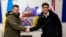 British Prime Minister Rishi Sunak( (right) and Ukrainian President Volodymyr Zelenskiy (left) sign a declaration of unity at a military facility in Lulworth, Dorset, Britain, on February 8.