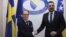 Swedish Foreign Minister Tobias Billstroem (left) shakes hands with Bosnian counterpart Elmedin Konakovic in Sarajevo on April 20.