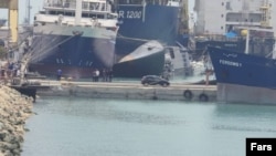 The Iranian destroyer Sahand is seen capsized in the port of Bandar Abbas.