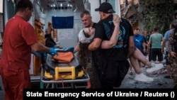 Rescuers work at the site where a building was destroyed during a Russian missile strike in Pokrovsk, in Ukraine's Donetsk region, on August 7.