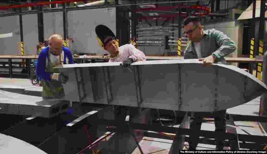 Ukrainian workers handle a section of the trident shield that is currently being built at an undisclosed location. Funding for the 28 million hryvna ($758,000) steel shield was raised with donations from various large Ukrainian businesses.&nbsp;