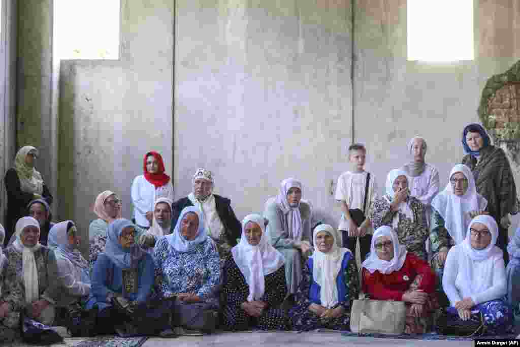 Muslim women pray next to 30 coffins containing the remains of their loved ones in Potocari, Bosnia-Herzegovina, on July 9. Their family members were&nbsp;victims of the 1995 Srebrenica genocide. The remains were to be buried on July 11 following a commemorative ceremony marking the 28th anniversary of the massacre, Europe&#39;s only&nbsp;acknowledged genocide since World War II.