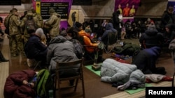 People take shelter inside a metro station during an air-raid alert in Kyiv on January 8.
