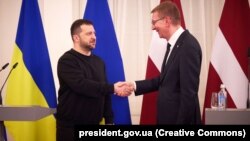 Ukrainian President Volodymyr Zelenskiy (left) meets his Latvian counterpart, Edgars Rinkevichs. in Riga on January 11. 