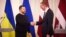 Ukrainian President Volodymyr Zelenskiy (left) meets his Latvian counterpart, Edgars Rinkevichs. in Riga on January 11. 