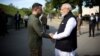 Indian Prime Minister Narendra Modi (right) and Ukrainian President Volodymyr Zelenskiy shake hands before visiting a memorial to children killed during Russia's attack on Ukraine, in Kyiv on August 23. 