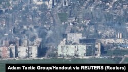 UKRAINE – Smoke erupts following a shell explosion, amid Russia's attack on Ukraine, in Bakhmut, in this screengrab obtained from a handout video released on May 7, 2023