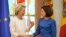 Moldovan President Maia Sandu (right) welcomes European Commission President Ursula von der Leyen during a media conference in Chisinau prior to the start of the European Political Community Summit on May 31.
