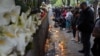 People leave flowers, toys and candles outside the school in Belgrade on May 4.