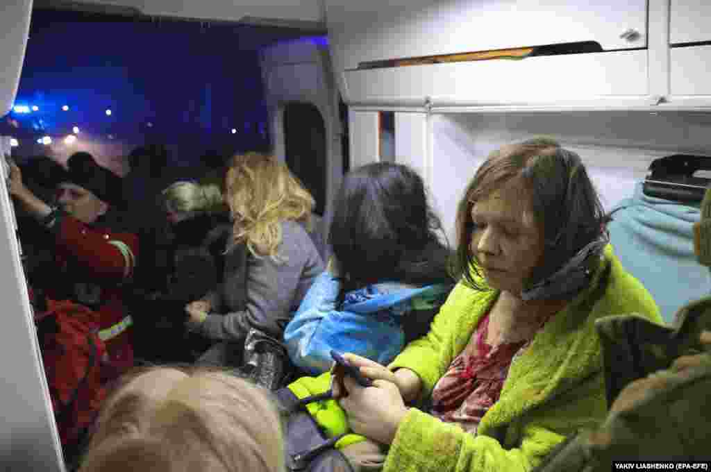 ...while locals sit in an ambulance to stay warm.