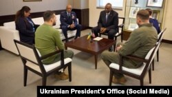 Ukrainian President Volodymyr Zelenskiy (front left) meets with U.S. Defense Secretary Lloyd Austin (center right) in Washington, D.C., on December 11.
