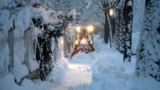 A snow plow cleans a road after heavy snow fall in Munich, Germany, Saturday, Dec. 2, 2023.