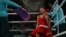 A Kazakh boxer catches his breath between rounds at a match during the Paris Olympics.