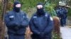 German police secure the area after 25 suspected members and supporters of a far-right group were detained during raids across Germany, in Berlin on December 7.