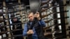 Ukraine -- A customer checks his rifle in a gun shop in Lviv