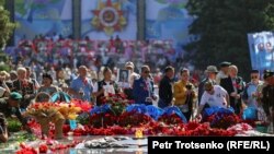 Люди у Вечного огня в парке 28 гвардейцев-панфиловцев в Алматы. 9 мая 2022 года 