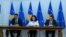 Kosovar Parliament Speaker Glauk Konjufca (left), President Vjosa Osmani (center), and Prime Minister Albin Kurti sign the EU membership application on December 14. 