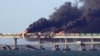 Black smoke billows from an explosion on the Kerch Bridge that links Crimea to Russia on October 8, 2022.