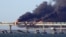 Black smoke billows from an explosion on the Kerch Bridge that links Crimea to Russia on October 8, 2022.