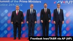 From left: Prime ministers Viktor Orban of Hungary, Petr Fiala of the Czech Republic, Eduard Heger of Slovakia, and Mateusz Morawiecki of Poland pose for a photo after a Visegrad Group summit in Kosice, Slovakia, on November 24.