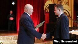 Belarusian strongman Aleyaksandr Lukashenka (left) presents an award to Syarhey Adzyarykha in 2020. 