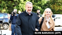 Sebija Izetbegovic (right) arrives with her husband to cast their votes in elections in Sarajevo in October 2022. 