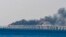 Дым от пожара на Керченском мосту после взрыва, Керчь, 8 октября 2022 года