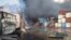 Containers burn on April 27 at the site of a massive explosion and fire that rocked a port near the southern port city of Bandar Abbas, Iran.

