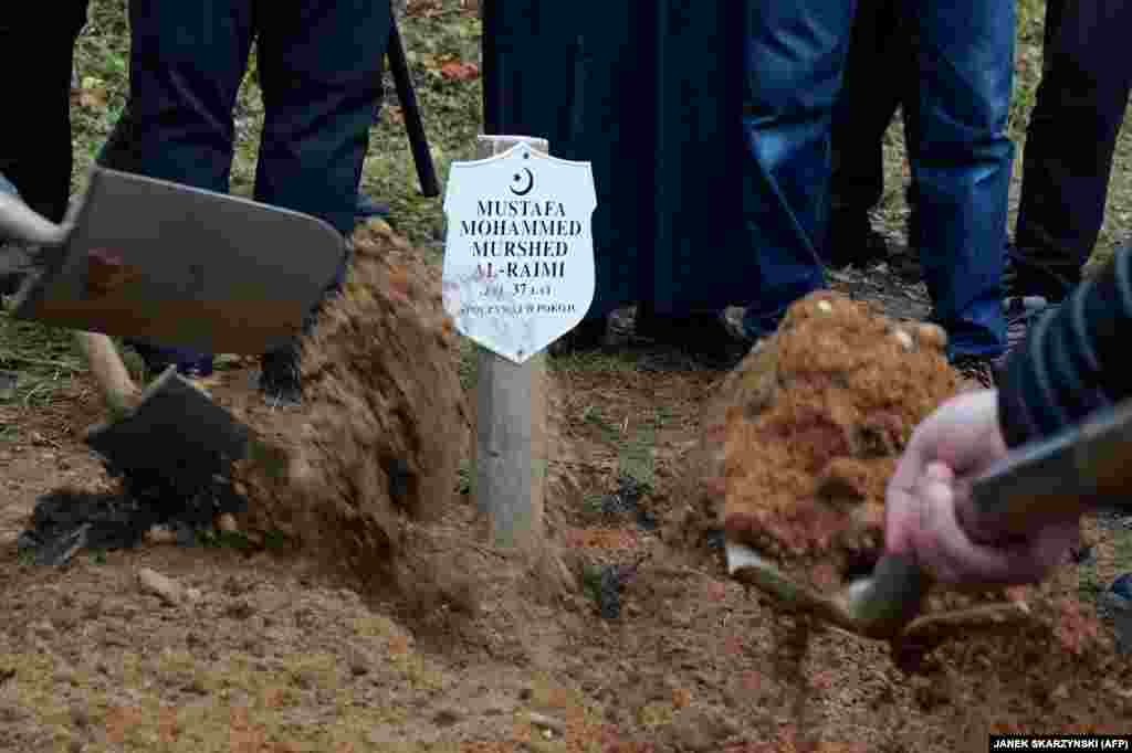 Mourners fill al-Raimi&#39;s grave at his funeral. Poland says at least 11 would-be migrants have died since the crisis began during the summer.