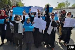 Afghan women and girls take part in a protest in front of the Education Ministry in Kabul on March 26, 2022, demanding that high schools be reopened for girls.