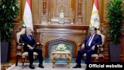 Abdullah Abdullah (left), who heads Afghanistan's High Council for National Reconciliation, traveled to Dushanbe to meet with Tajik President Emomali Rahmon (right) and other top officials on December 22.