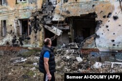 60-річний чоловік перевіряє руїнації, Ізюм