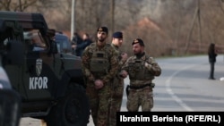 KFOR troops arrive at the scene of a roadblock in Rudare in northern Kosovo in late December.