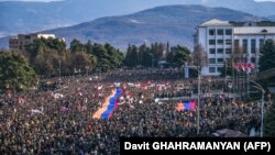 Nagorno-Karabakh - Protesters hold a giant Armenian flag as they attend a rally in Stepanakert, December 25, 2022. 