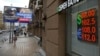 People walk past a currency-exchange office in Moscow in August.