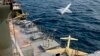 A drone is launched from a warship in a military drone drill in Iran. 