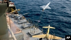 A drone is launched from a warship in a military drone drill in Iran. 