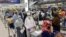 Afghan citizens wait for airline transfers at the airport in New Delhi, India, following the Taliban's takeover of Afghanistan last August.