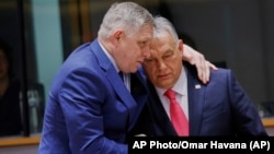 Slovak Prime Minister Robert Fico (left) speaks with his Hungarian counterpart, Viktor Orban, at an EU summit in Brussels earlier this year. 