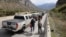 People walk by a line of vehicles on the road for the Verkhny Lars checkpoint on the Russian-Georgian border in September 2022. According to the Georgian Interior Ministry, around 78,000 Russians arrived in Georgia from September 17-26. 