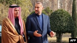 Iranian Foreign Minister Hossein Amir-Abdollahian (right) greets his Qatari counterpart, Mohammed Bin Abdulrahman Al-Thani, in Tehran on January 29. In recent weeks, Iran has expressed interest in holding meetings with regional leaders.