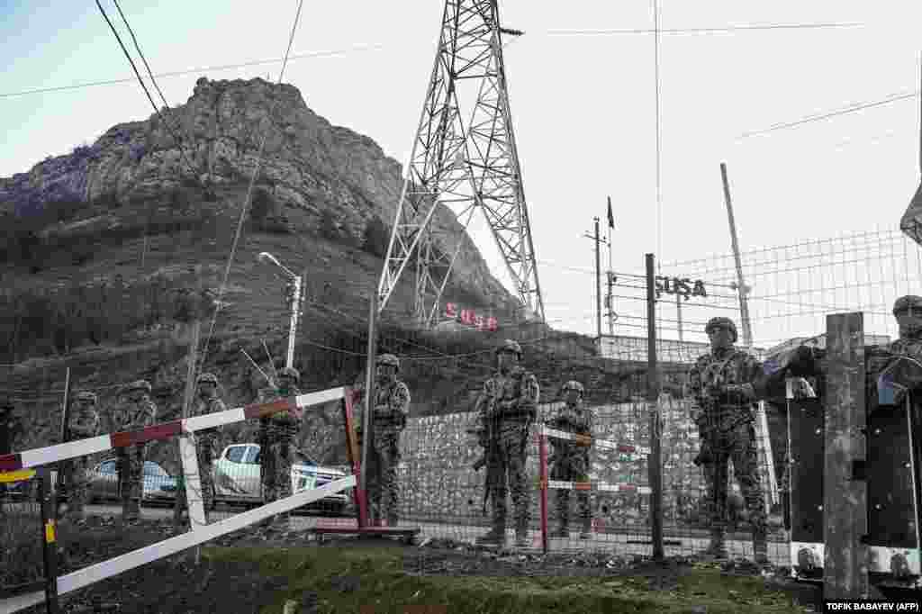 Azerbaijani servicemen guard a checkpoint at the Lachin Corridor. Armenia contends the protests are orchestrated by Azerbaijan, and the United States has called on Baku to lift the blockade.&nbsp; &nbsp;
