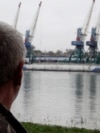 Plauru resident Gheorghe Puflea looks across the Danube at the Ukrainian port of Izmail.