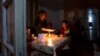 Nagorno-Karabakh - A woman and her son have a dinner at their home in Stepanakert, during a power blackout, January 18, 2023.
