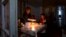 Nagorno-Karabakh - A woman and her son have a dinner at their home in Stepanakert, during a power blackout, January 18, 2023.