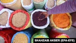 A man sells lentils at a wholesale grocery market in Karachi.
