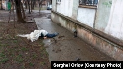A Ukrainian civilian lies dead on the streets of Mariupol during Russia's brutal siege of the city last year. 